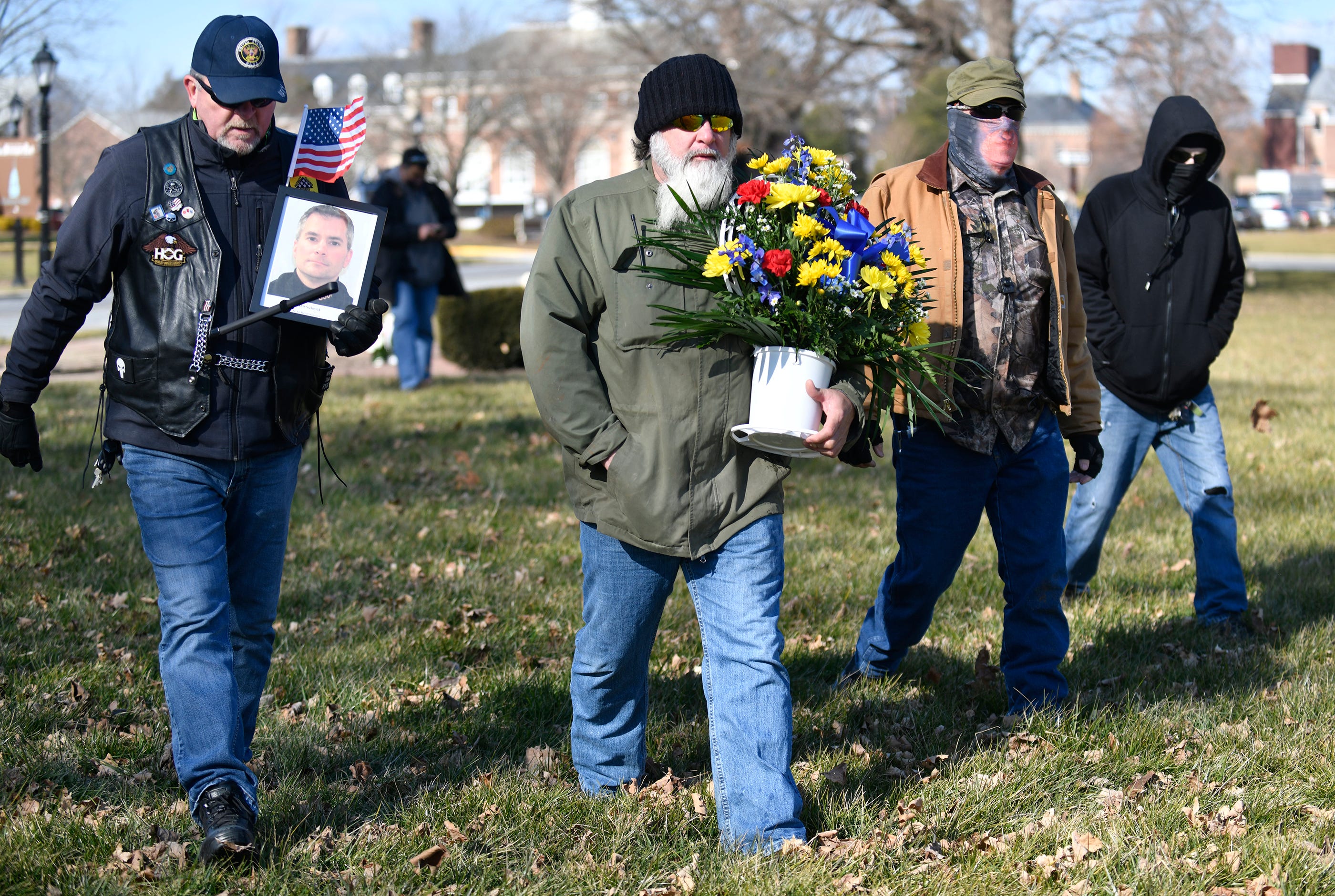 A group of men held a vigil for U.S. Capitol Policeman Brian D. Sicknick, who died after sustaining injuries during the Capitol riots, at the Legislative Mall in Dover, Del., on Wednesday, Jan. 20, 2020.