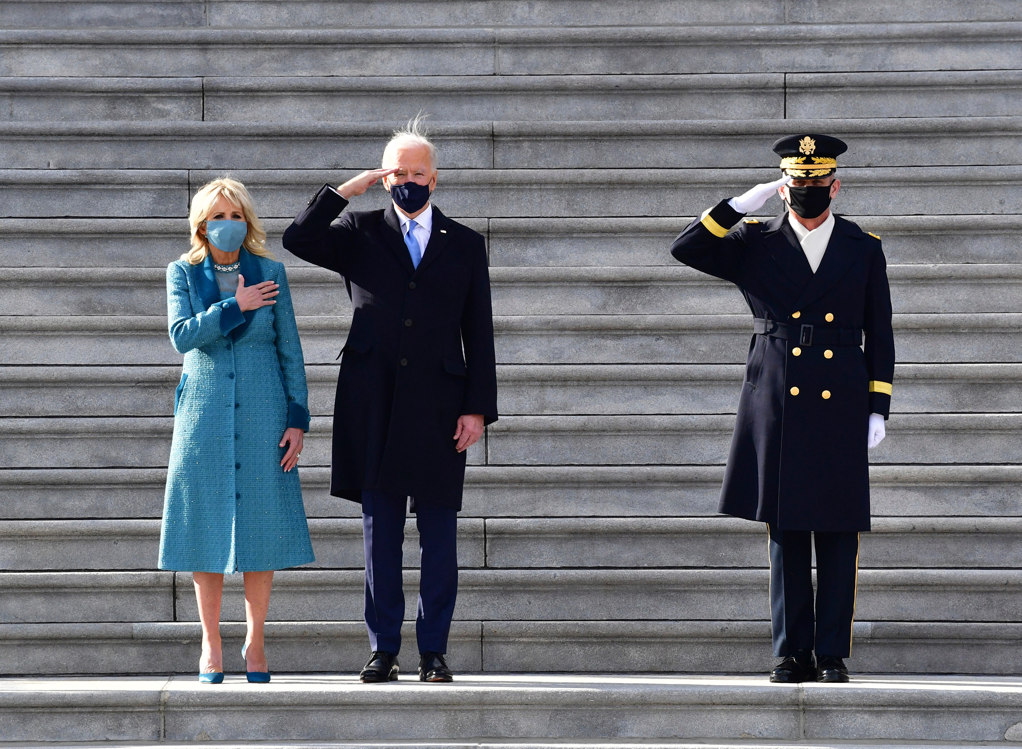 President Joe Biden salutes as wife Jill Biden puts her hand on her heart on the east steps of the U.S. Capitol after Biden is sworn in as the 46th President of the United States on Wednesday, Jan.  20, 2021 in Washington.