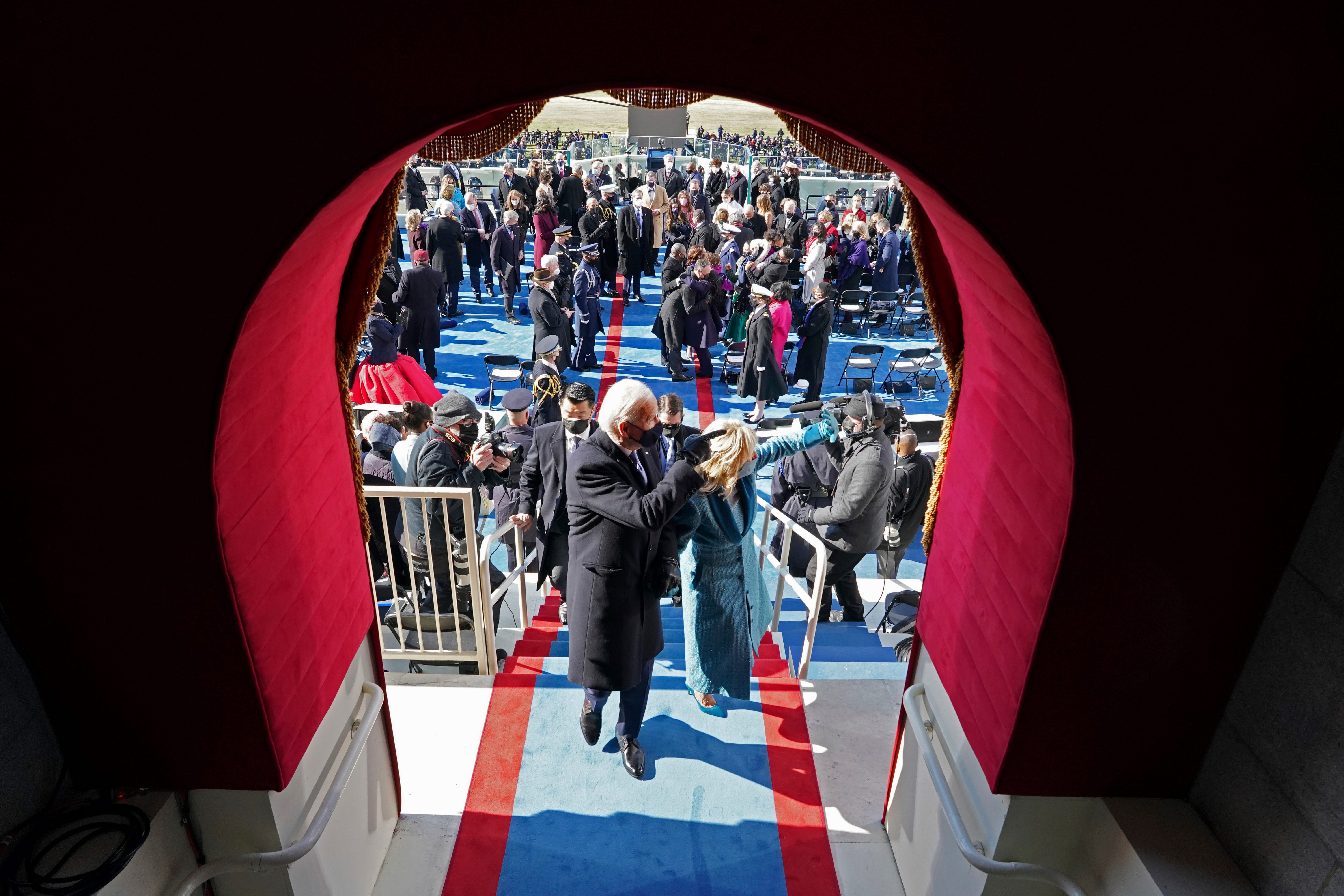 President Joe Biden and first lady Jill Biden gesture as they leave after his inauguration at the U.S. Capitol in Washington, Wednesday, Jan. 20, 2021.