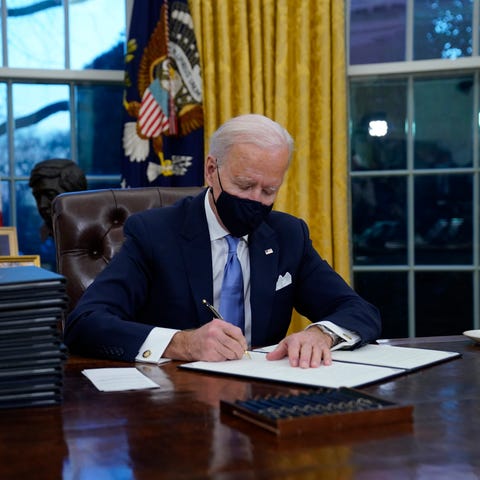 President Joe Biden signs his first executive orde