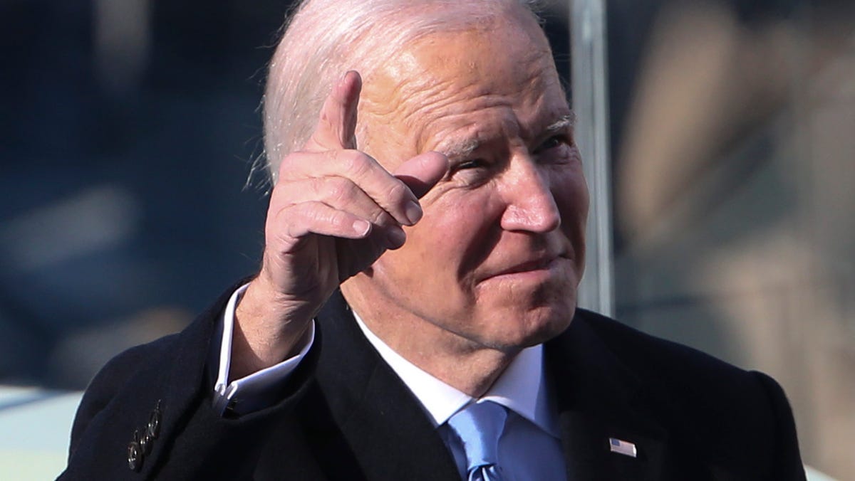 President Joe Biden gestures to crowd members after taking the oath of the presidency during the 2021 Presidential Inauguration of President Joe Biden and Vice President Kamala Harris at the U.S. Capitol.