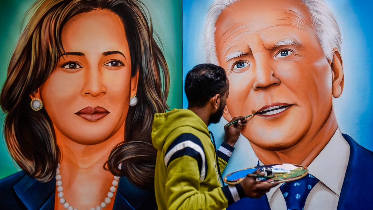 Painter Jagjot Singh Rubal gives the final touches to a painting depicting US President-elect Joe Biden and Vice President-elect Kamala Harris in Amritsar on January 19, 2021.