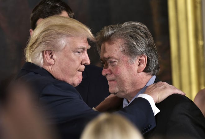 Then-President Donald Trump congratulates Senior Counselor to the President Steve Bannon at the White House in Washington, D.C., on Jan. 22, 2017.