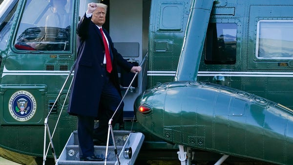 President Donald Trump gestures as he boards Marin