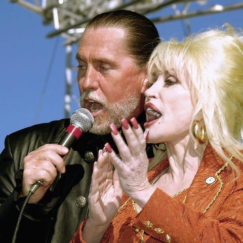 Dolly Parton shares the microphone with her brothe