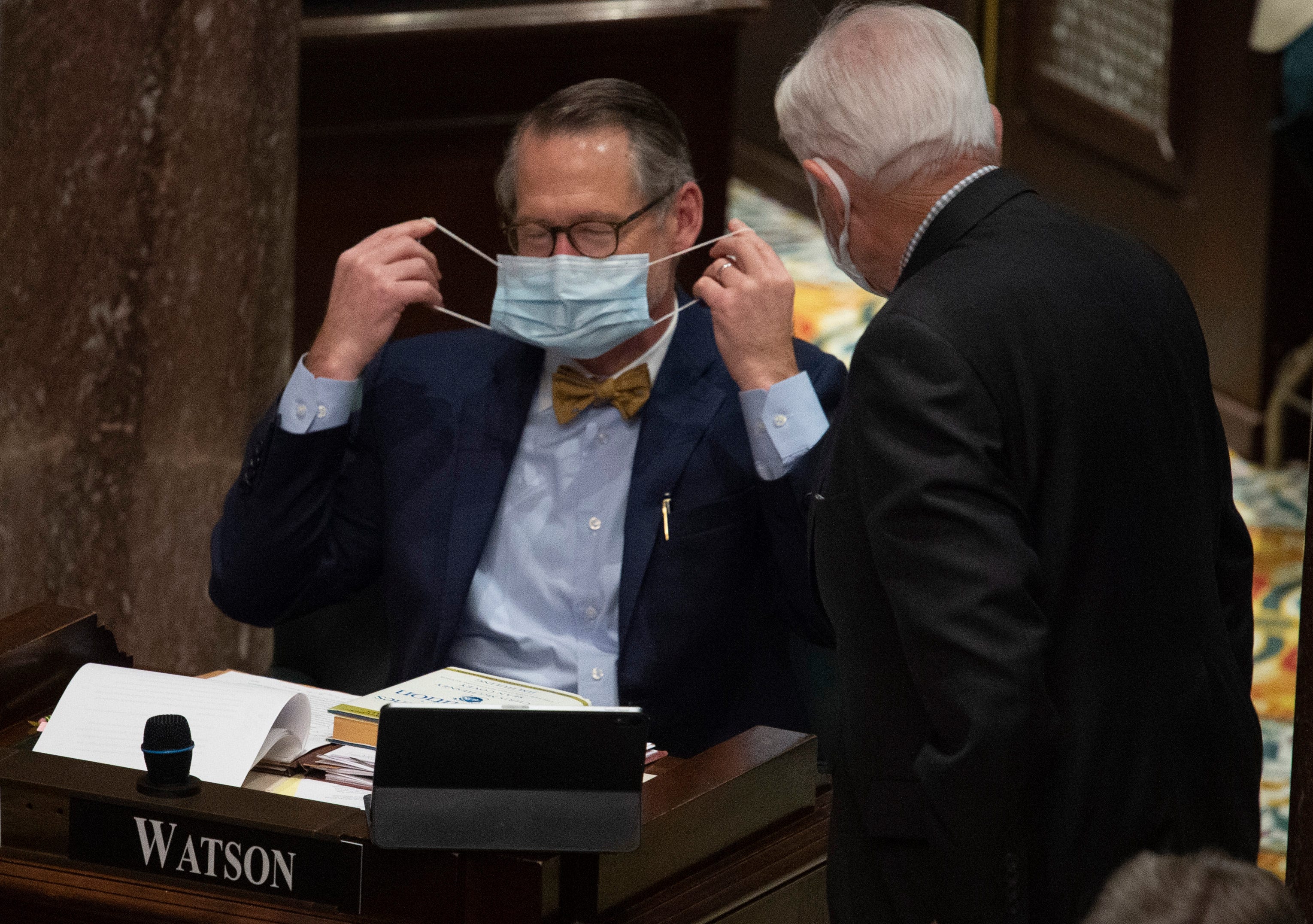 State Sen. Bo Watson covers his face as he chats with Sen. Ken Yager during a special session of the Senate at the State Capitol Thursday, Jan. 21, 2021 in Nashville, Tenn.