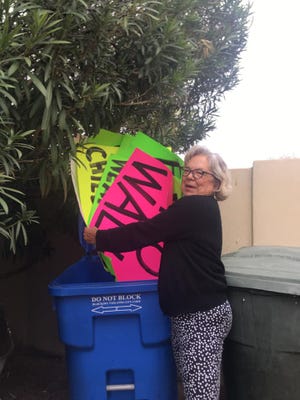 Lynne Avril gathered protest signs from her garage and dumped them, save one, in the recycling bin the day before President Joe Biden's inauguration.