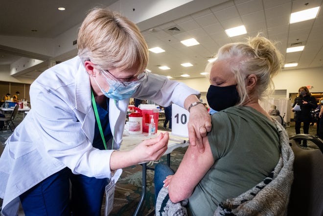 SC4 clinical instructor and registered nurse Laurie Lamont, left, administers a dose of the COVID-19 vaccine to Barb Murtagh, of St. Clair, during a vaccination clinic for seniors Thursday, Jan. 21, 2021, at the Blue Water Convention Center in Port Huron.