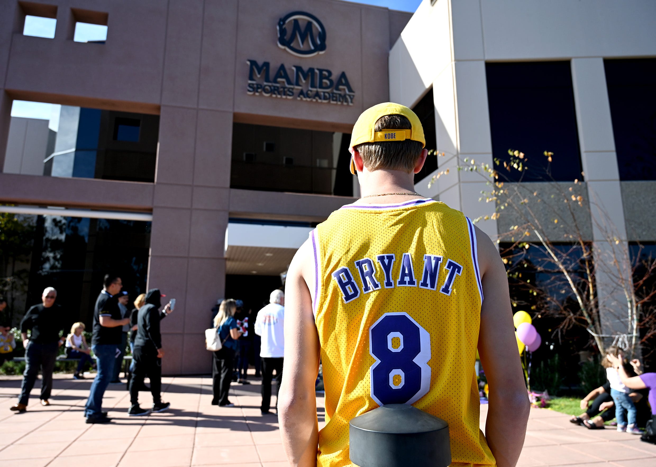 A Kobe Bryant fan joins other people in grieving Bryant's a day after a deadly helicopter crash.