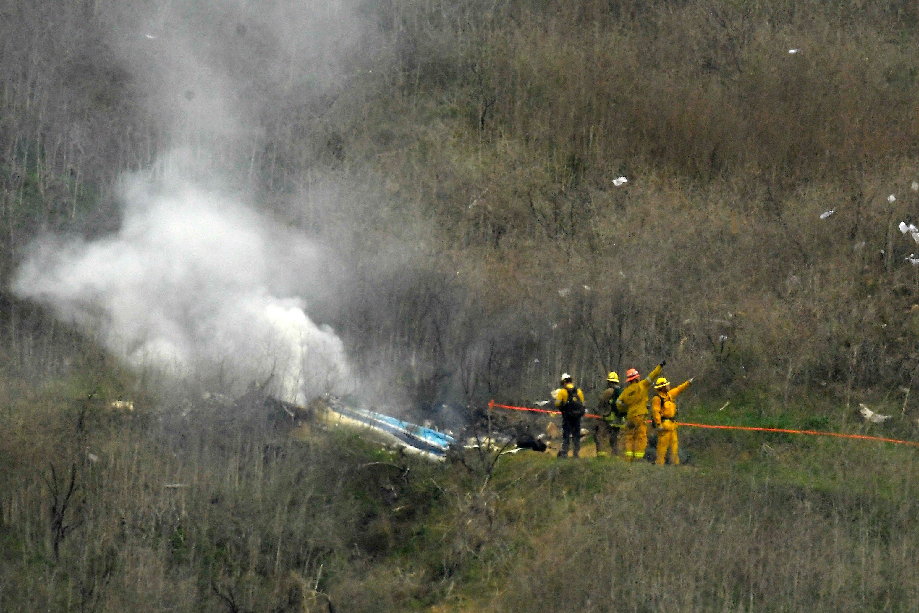 Firefighters work the scene of a helicopter crash in Calabasas, California where Kobe Bryant and eight others died.