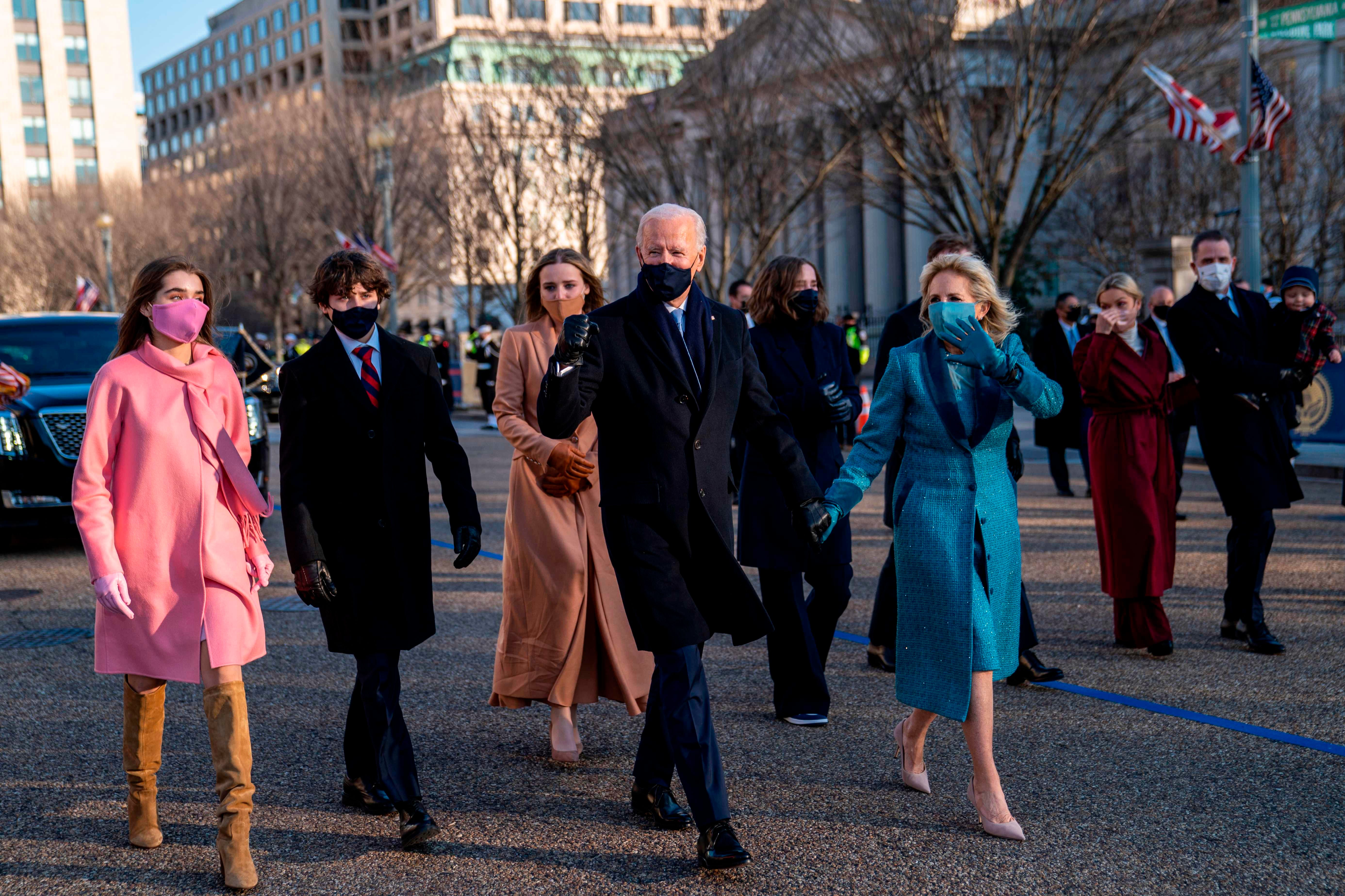 President Joe Biden and first lady Jill Biden walk along Pennsylvania Avenue in front of the White House during Inaugural celebrations, on January 20, 2021 with family members after US President Biden was sworn in as the 46th President of the United States.