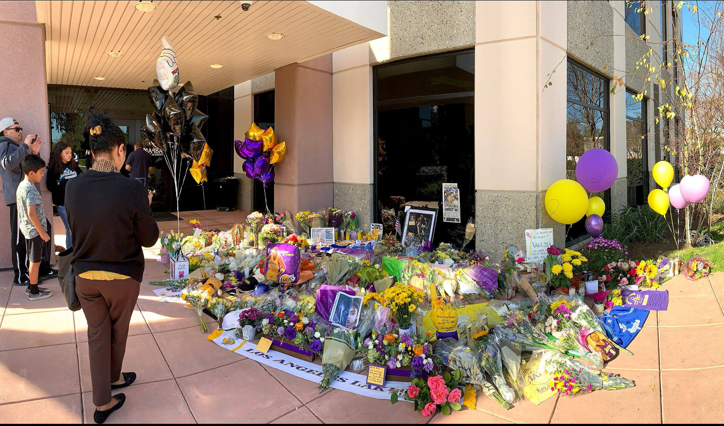 People gather at the Mamba Sports Academy to pay tribute to Kobe Bryant following his death.