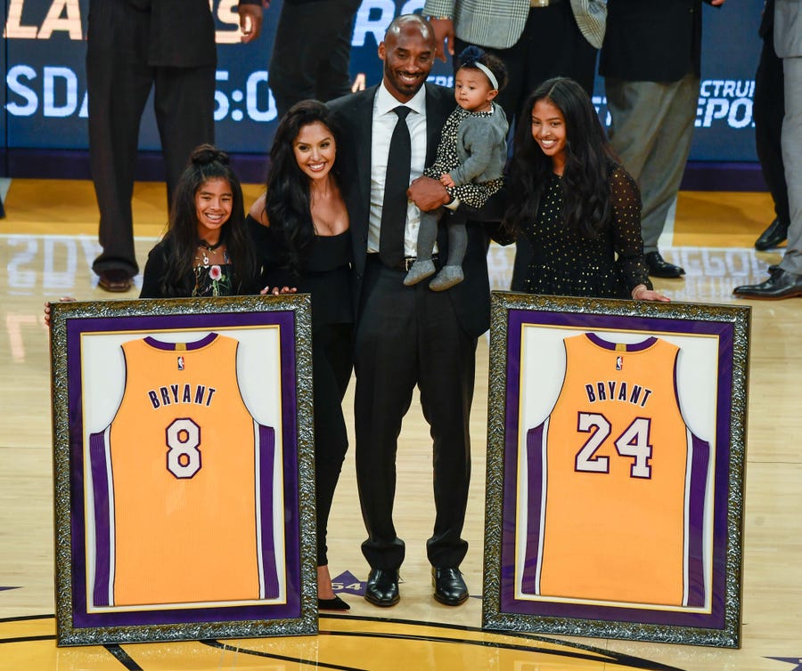 Kobe Bryant is joined by his family, Gianna, Vanessa, Bianka and Natalia, during a ceremony retiring his two uniform numbers at Staples Center in Los Angeles on Dec 18, 2017.
