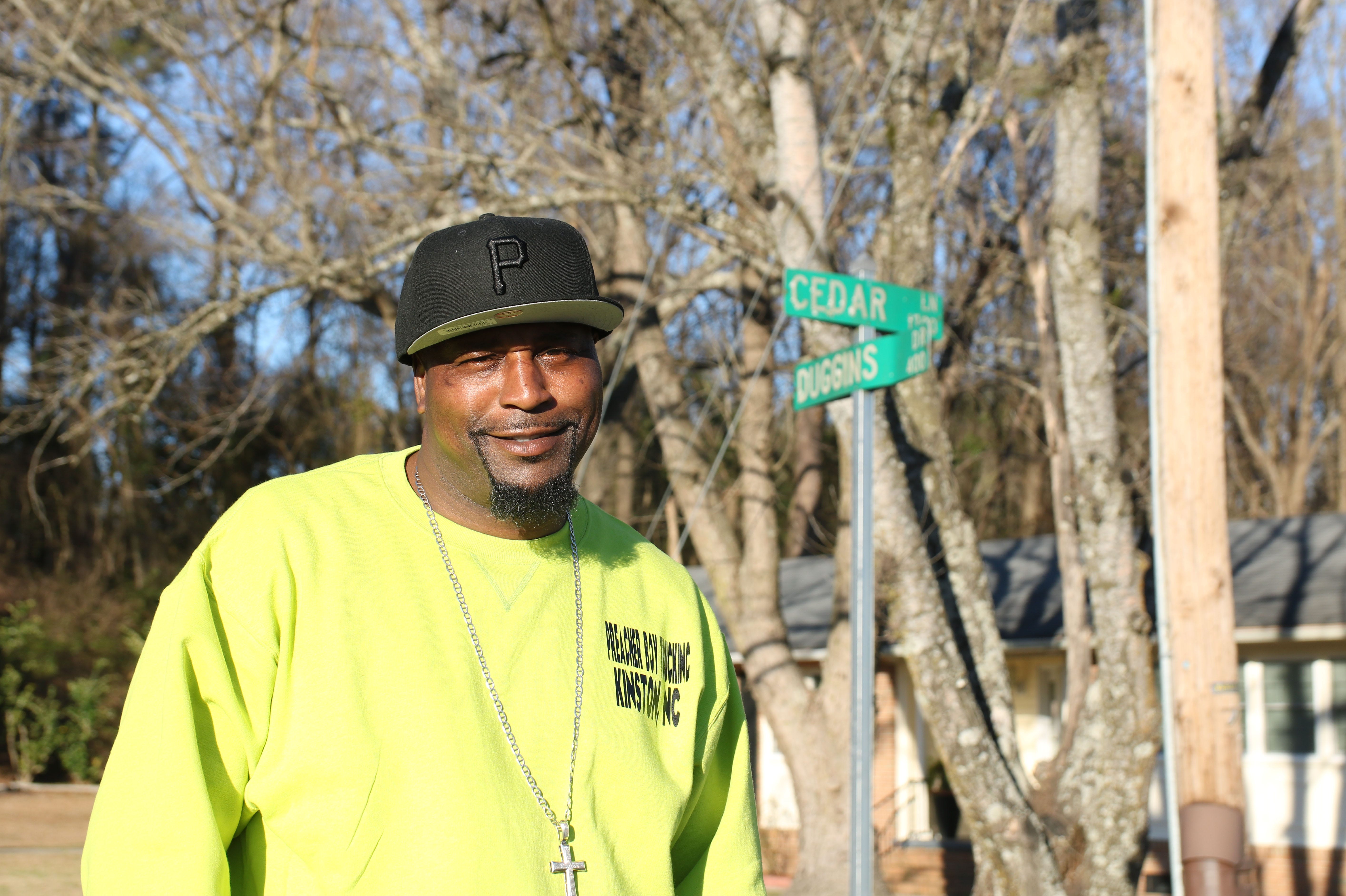Tyshun Wilson stands at the corner of Cedar Lane and Duggins Drive in East Kinston where he grew up.