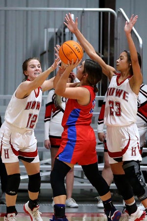 Howe's Caitlyn Stacy, left, and Raelyn Delt, look to trap Whitesboro's Madi Edwards in the second quarter, Thursday, Jan. 21, during the annual LeFlore County Basketball Tournament at Howe.