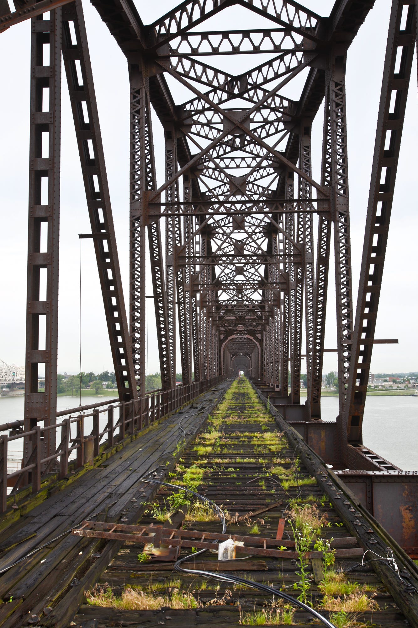 The ramp and the structural steel of the bridge make a stark outline on the Louisville horizon. The General Assembly approves $12 million in funding to re-deck the Big four bridge.
(Photo by Pam Spaulding, the Courier-Journal)
June 3, 2010