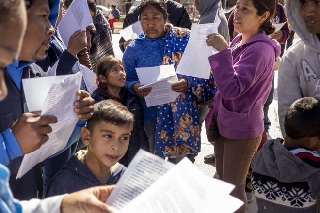 Migrants read a handout about new immigration law while the Migrant Protection Protocols expanded to Nogales, Sonora in early January. One month later, it remains tough to gauge is full impact on this border city as apprehensions continue dropping, but asylum seekers continue arriving.