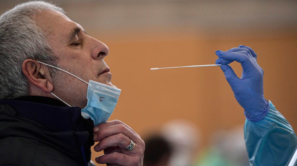 A  swab is taken from a resident, during a rapid antigen test for COVID-19 in Andosilla, around 40 miles from Pamplona, northern Spain, Friday, Jan. 22, 2021. Local authorities have called for more than 500 residents to be tested due to the increase of people in the town contracting coronavirus.