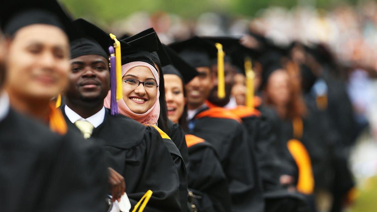 Students graduate at City College on June 3, 2016, in New York City. The debt many grads face right out of college has continued to climb.