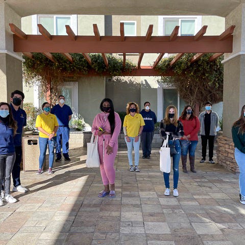 Two Victor Valley College students, center, stand 