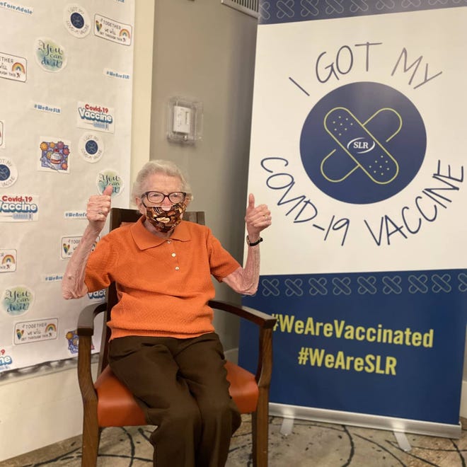 Forestdale Park resident Virginia Ruane gives two thumbs up after receiving her COVID-19 vaccine.