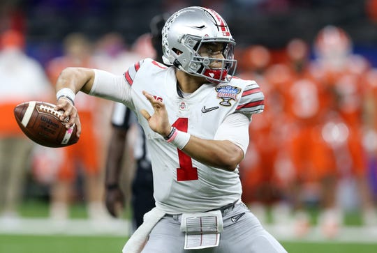 Ohio State quarterback Justin Fields attempts a pass in the College Football Playoff semifinal against Clemson at the Allstate Sugar Bowl in the Mercedes-Benz Superdome in New Orleans on Jan. 1, 2021.