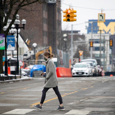 A pedestrian crosses the street in downtown Ann Ar