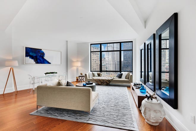An oversized rug adds a sense of spaciousness in this loft-style space.