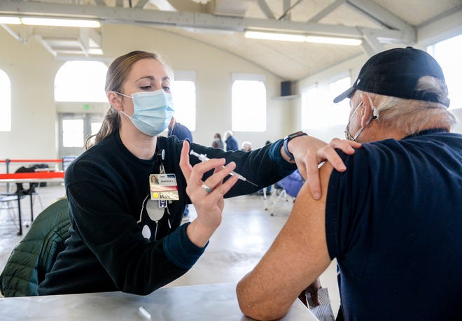 Cascade County is experiencing a slight increase in the COVID-19 case rate with 25 cases per 100,000 people. Pictured above, Benefis nurse Marissa Lencioni administers the Pfizer COVID-19 vaccine to Great Falls resident Mick Cabbage during a vaccination clinic.