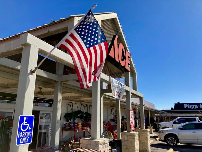 American flag flying outside Fredericksburg hardware store owned by GOP state Rep. Kyle Biedermann, who has filed legislation calling for statewide vote on Texas secession from the United States.