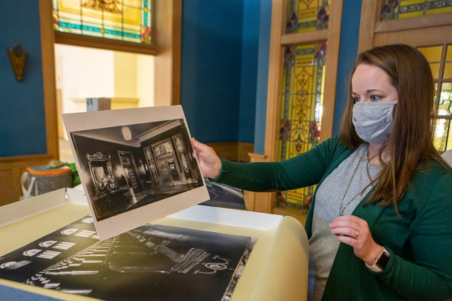 Courtney Stemler looks through old photographs of the historic Woman's Club of Topeka building, at 420 S.W. 9th St., late last year. Stemler, along with three other business partners, purchased the building from auction and plan to turn the space into an event venue named The Beacon.