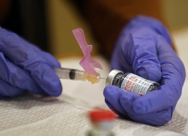A syringe is loaded with the Moderna COVID-19 vaccine at a vaccine clinic in Kitsap County on Jan. 26.