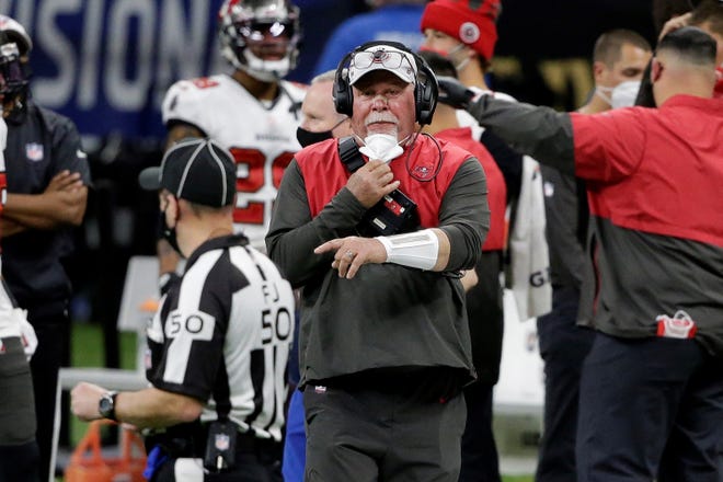 Tampa Bay Buccaneers head coach Bruce Arians speaks with field judge Aaron Santi (50) during the second half of his team's NFL divisional round playoff football game against the New Orleans Saints, Sunday, Jan. 17, 2021, in New Orleans. (AP Photo/Butch Dill)