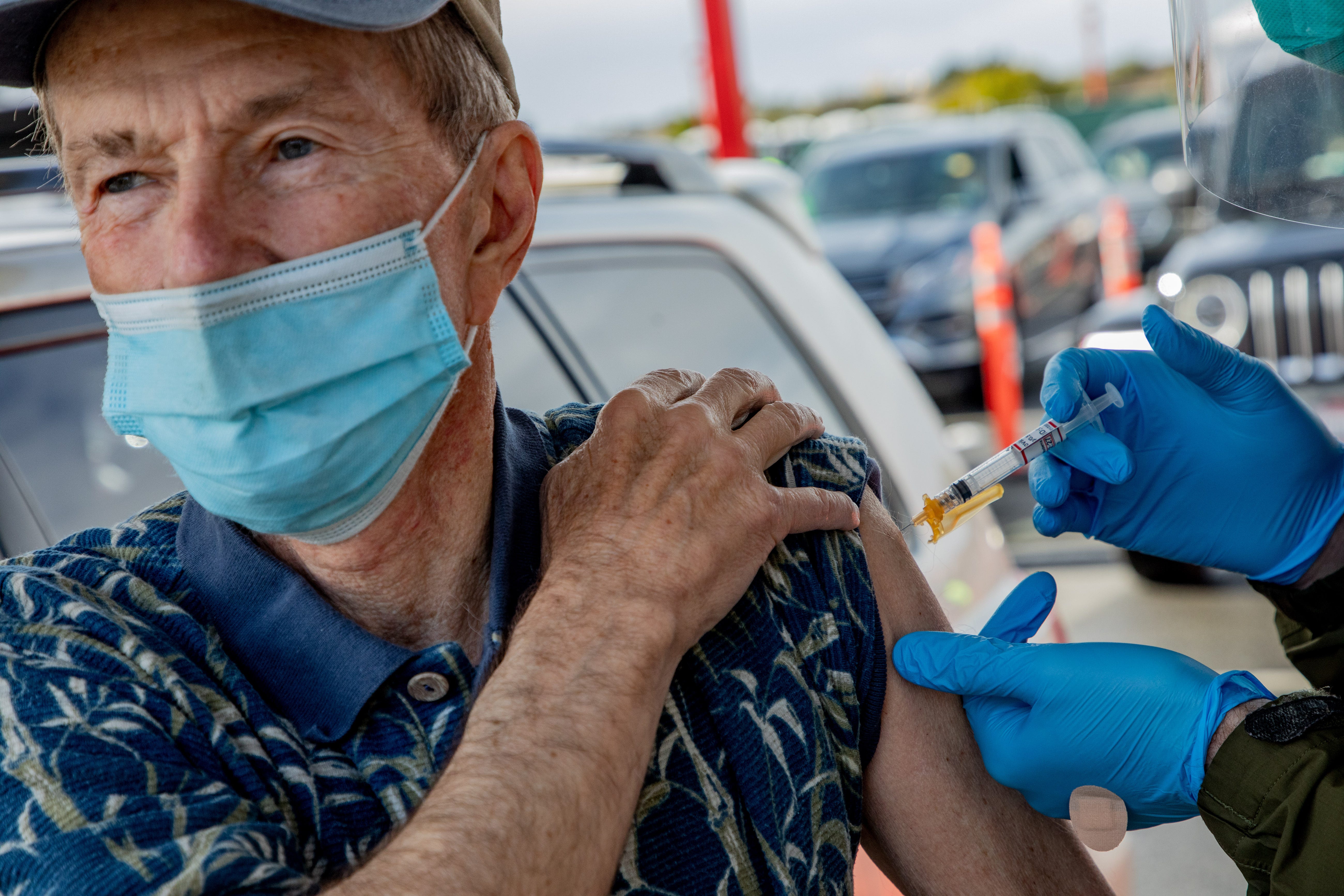 Ralph Kenney, 77, receives the Moderna COVID-19 vaccine at a mass vaccination site at City College of San Francisco on Jan. 22. He called it "the best present" he could get on his wedding anniversary.