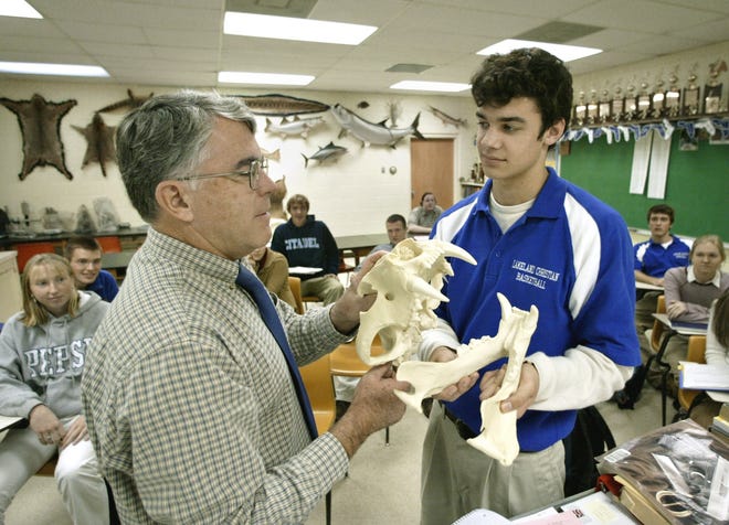 (L-R) Mike Musick, Chairman Science Department, examines a Siberian Tiger skull with junior Mark Livesay, 17, at Lakeland Christian School in Lakeland in 2003.