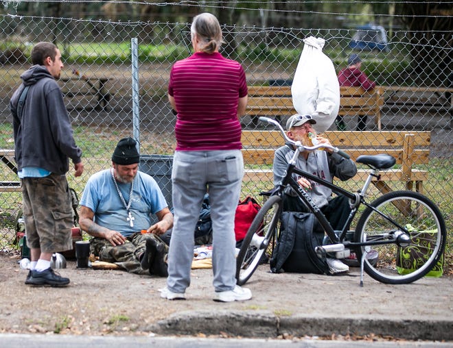 Some homeless men hang outside on the sidewalk near Interfaith Emergency Services on Jan. 27. A federal court ruling has taken issue with the City of Ocala's Open Lodging ordinance.