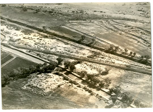 This aerial photograph circa 1929, with labels, shows the unexcavated Pueblo Grande platform mound and the prehistoric canals in the Park of Four Waters.