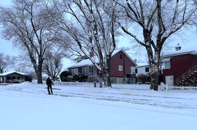 A man snowboards down Walker Avenue in southwest Reno Jan. 27, 2021.