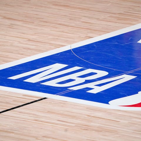 The NBA logo is displayed at center court during a
