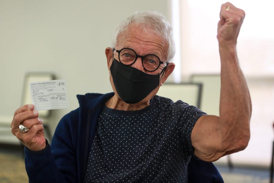 Palm Desert resident Luther Wood, 82, celebrates his Pfizer COVID-19 vaccination at Eisenhower Health's clinic for patients age 75 and older on Jan. 26 in Rancho Mirage, Calif.
