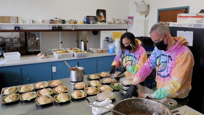 Rochelle Mendes, left, and Ronnie Burns prepare shopksa salad at the Provincetown Soup Kitchen on Jan. 28, 2021. The two volunteers work at Curaleaf, a cannabis retailer. As part of Curaleaf's host agreement, their employees volunteer in the community.