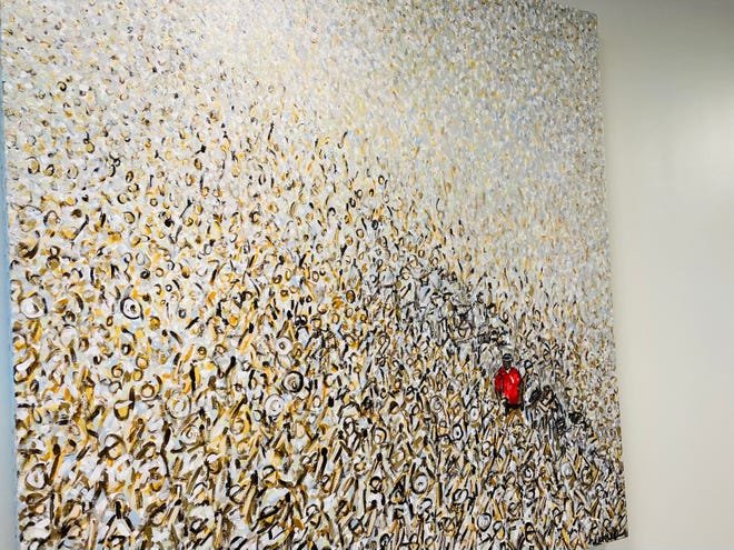 Sisters Holly and Heather Blanton collaborated on this artwork that is on a wall at the PGA Tour's Global Home, depicting Tiger Woods walking down the 18th fairway of the East Lake Golf Club in Atlanta when he won the 2018 Tour Championship.