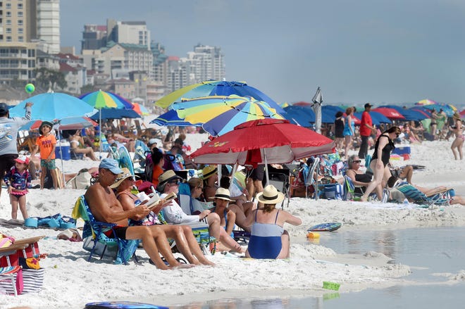 A summer crowd fills part of Walton County's 26 miles of public and private beaches. Walton County commissioners, as part of a review of the county's beach activities ordinance, will seek proposals for a digital app to enhance visitors' experiences.