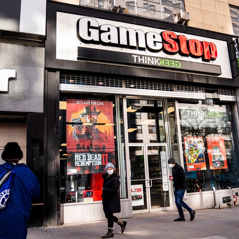 Pedestrians pass a GameStop store on 14th Street a
