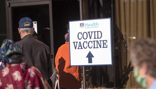 People line up for COVID-19 vaccinations on Thursday at Warren Baptist Church in Augusta, Ga.