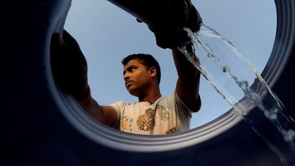 Mukindra Suryawanshi, 22, fills his family's water