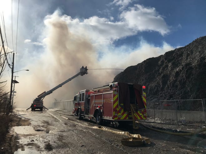 Camden firefighters battled high winds and cold temperatures, as well as a fire in a pile of industrial waste in South Camden on Friday morning.