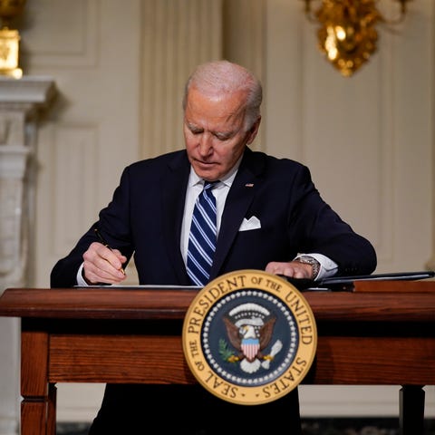 President Joe Biden signs an executive order on cl