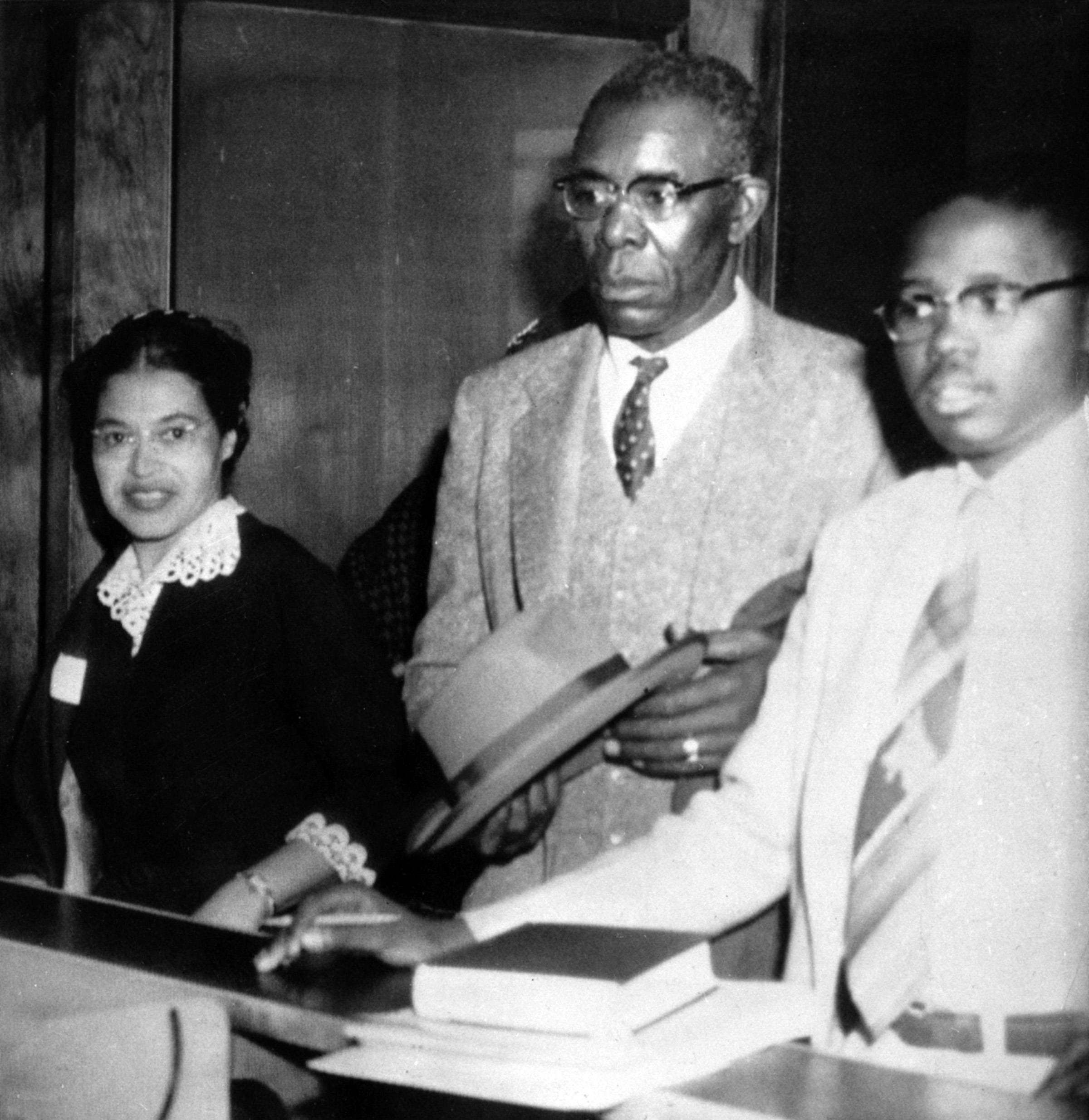 Rosa Parks, left,  makes bond to Circuit Court in December 1955 for violating Montgomery's segregation ordinance for city buses. Signing the bond were former state NAACP President E.D. Nixon, center, and attorney Fred Gray.  
