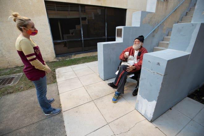 City Walk Urban Mission Executive Director Renee Miller speaks to shelter customer Darwin Phillips at the Mahan Drive shelter on Thursday, January 28, 2021.